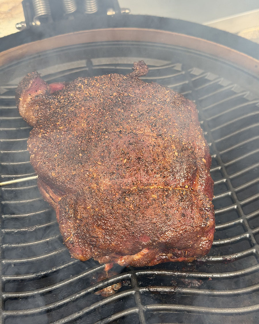 Seasoned meat cooking on a smoker
